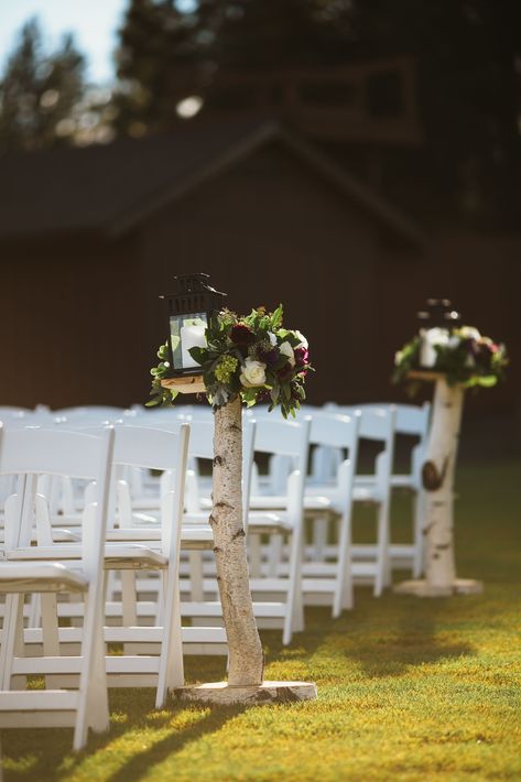 The aisle lined with birch tree trunks had lush flower arrangements of hydrangeas, roses and eucalyptus on top, along with a white candle inside a black lantern. Birch Tree Wedding Arch, Tree Wedding Arch, Birch Wedding Decor, Birch Trees Garden, Birch Tree Decor, Birch Tree Wedding, Birch Wedding, Tie The Knot Wedding, Nature Inspired Wedding