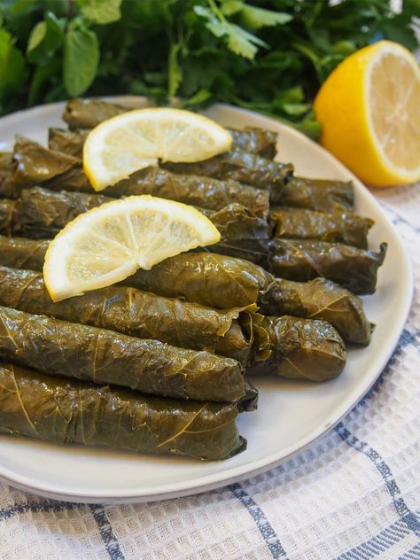 These Turkish stuffed grape leaves, yalancı dolma, have a simple vegetarian filling of mainly rice, herbs and currants. They're bright, tasty and comforting - a great addition to any meze platter. Dolmades Greek, Greek Dolmades, Dolmades Recipe, Dolma Recipe, Grape Leaves Recipe, Turkish Dishes, Meze Platter, Salad Appetizer Cups, Stuffed Grape Leaves