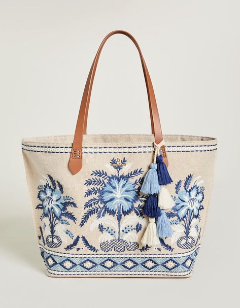 The best party is a beach party and our Fiesta Tote is always ready to come along! Decorated with palm tree embroidery on a cotton and jute blend, this tote features a fun, tiered tassel fob and a faux leather bottom base to keep it dry. The custom patterned cotton interior features 2 slip pockets and 1 hanging zipper Palm Tree Embroidery, Lowcountry Style, Tree Embroidery, Spartina 449, Embroidered Quilts, Quilted Tote Bags, Best Party, Beach Gifts, Quilted Totes