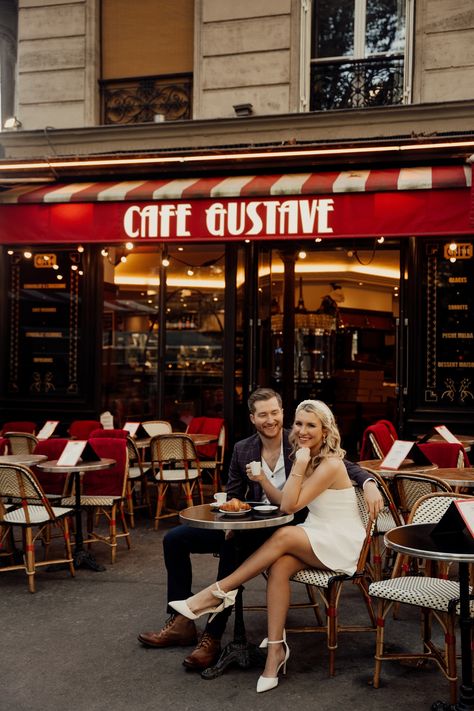 A couple is taking engagement photos at Parisian Cafe Cafe Engagement Photos, Coffee Shop Engagement Photos, Cafe Couple Photoshoot, Coffee Engagement Photos, Paris Shoot, Paris Engagement Photos, Wedding Lunch, City Photoshoot, Paris Engagement