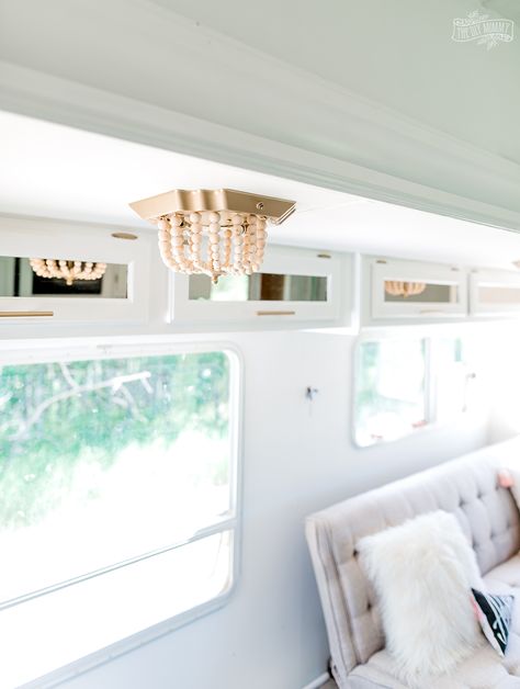 See how I transformed a flush mount fixture in our camper with this ceiling light DIY $7 boho makeover! Diy Camper Light Cover, Rv Light Cover Ideas, Diy Rv Lighting Fixtures, Rv Light Fixture Makeover Diy, Diy Rv Light Covers, Camper Light Fixtures, Rv Light Fixture Makeover, Light Covers Diy, Diy Wood Bead Chandelier