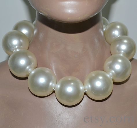 This necklace with 39.5 mm ivory color plastics pearl beads. There are smaller stainless steel ball between each pearl. You can choose the length when you order.and the necklace with two stainless steel circle and a stanless steel lobster clasp and it still has a 2 inch long adjustable chain. It is great gift for men, The weight of one bead is about 32.5 g. These are very big beads, Please you need to ensure to choose a right length. In the first picture, there are 12 beads in the necklace, It i Big Beaded Necklace, Big Baroque Pearl Necklace, Giant Pearl Necklace, Big White Pearl Necklace, Pearl White Large Beads Pearl Necklace, Statement Pearl Choker, Huge Pearl Necklace, White Baroque Pearl Choker, Big Pearl Necklace