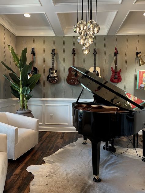 Music Room interior design. Piano on cowhide rug. Two side chairs. Vertical wallpaper design. Guitars hanging on wall. Coffered ceiling. Hanging globes chandelier. Music Room With Piano And Guitars, Piano Room Wallpaper, Nashville Interior Design, Rustic Music Room, Music Room With Piano, Farmhouse Music Room, Music Room In House, Classical Music Room, Music Room Interior Design