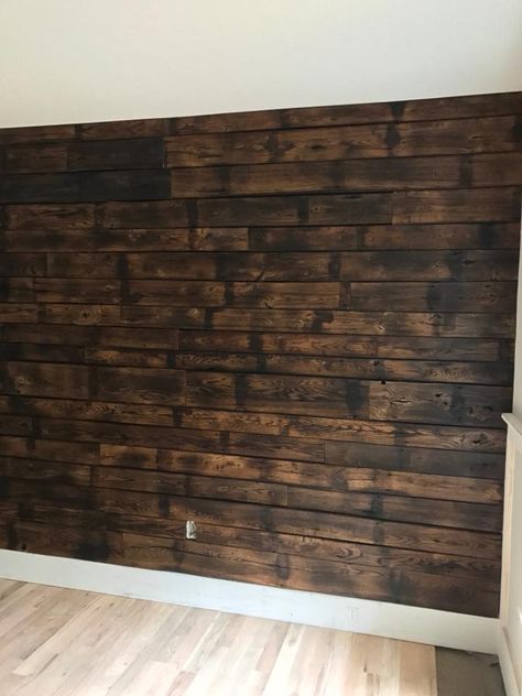 Also known as shou sugi ban, we charred oak for this accent wall. Pallet Wall Decor Living Room, Shou Sugi Ban Accent Wall, Burnt Wood Accent Wall, Burnt Wood Trim, Basement Accent Wall Ideas, Stained Wood Walls, Charred Wood Wall, Shou Sugi Ban Wall, Burned Wood Wall