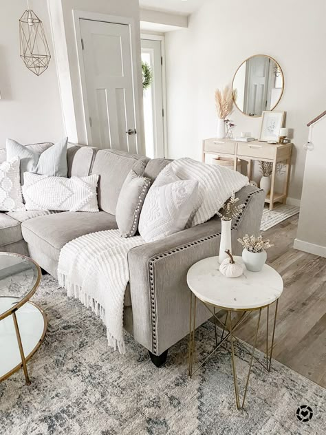 Neutral living room, grey corner sectional with nailhead trim, gold and marble geometric end table, gold and glass coffee table, blue and ivory neutral rug, neutral wooden console table, gold round mirror, entryway decor, entryway furniture, pampas, white vase http://liketk.it/34TUu #liketkit @liketoknow.it #LTKNewYear #StayHomeWithLTK #LTKhome @liketoknow.it.home #affiliate Farmhouse Sectional, Entryway Boho, Textured Pillows, White Living Room Decor, Grey Couch Living Room, Living Room Decor Neutral, Living Room Decor Gray, Beige Living Rooms, Gold Living Room