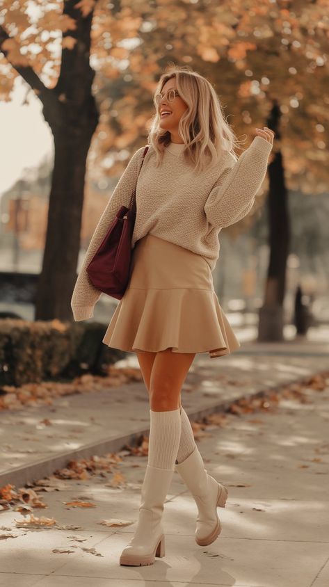 Turn heads this season with a striking blend of comfort and style! The light beige sweater paired with a flared skirt exudes a relaxed yet polished vibe. Elevate your outfit with white, thick high socks and fashionable white boots that are perfect for any outing. A vibrant burgundy bag provides a stunning focal point, ensuring you stand out from the crowd. #fallfashiontrends #fallfashion #outfitideas #outfittrends #autumnoutfit #fallioutfit #fashioninspo Beige Skirt Outfit, Beige Boots Outfit, Skirts And Boots, Dress Trending, Coordinates Outfits, Trendy Date Night Outfit, Burgundy Bag, The Flare, Art Outfit