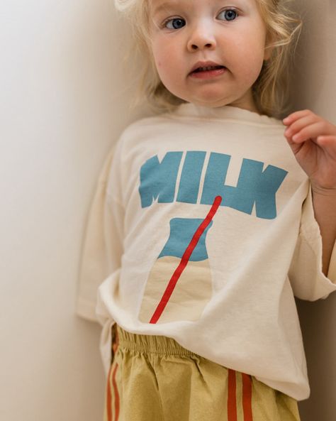 This super-cute slouchy milk tee, made with soft cotton, boasts an effortless and oversized design. Its short-sleeve style showcases a graphic milk detail on the front. Want to match your mini? We now have milk tees in a woman's size Fit: Slouchy, oversized fit Material: 100% cotton Features: Slight scoop-neckline, drop-shoulder sleeves, graphic milk detail at front. Colors: cream + dark grey Shipping: USA flat rate shipping International shipping calculated at checkout Shipping within 48 hours! Clothing Graphics, Wedding Dresses For Kids, Top Baby Products, Playsuit Romper, Swim Accessories, Toddler Fashion, Summer Kids, Baby Wearing, Baby Boy Outfits