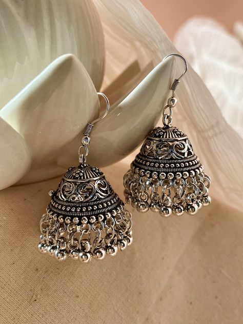 Introducing our petite wonders, the Ekta Oxidised Jhumka Earrings. A must-have for your oxidised collection, these dainty earrings evoke a tribal-inspired look that is sure to make a statement. Perfect for daily wear or dress up for an understated look. Please Note: We do not accept returns of earrings due to hygiene reasons. Unique Oxidised Earrings, Desi Earrings Aesthetic, Oxidised Jewellery Photography, Oxidised Earrings Jhumkas, Indian Earrings Aesthetic, Jhumka Earrings Aesthetic, Oxidised Jewellery Earrings, Jhumkas Aesthetic, Indian Earrings Jhumka