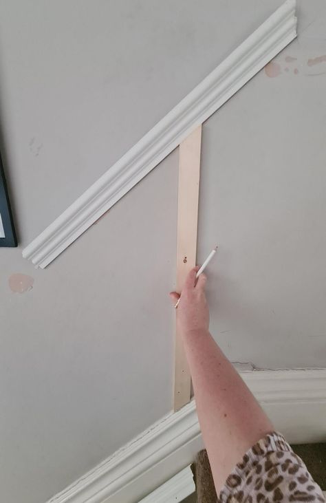 Looking for how to install wall panelling? This tutorial how to add wainscoting to your hallway is easy to follow and will help you panel your staircase with ease. Check out my nifty hack for working out the angles to cut! Read more now. Stair Panels Stairways, How To Do Panelling Up The Stairs, Hall Stairs And Landing Decor Panelling, Hall And Stairs Panelling Ideas, Staircase Design Panelling, Hallway Decorating Staircase, Panelling For Stairs, Diy Wall Paneling Stairs, Wall Panelling For Stairs