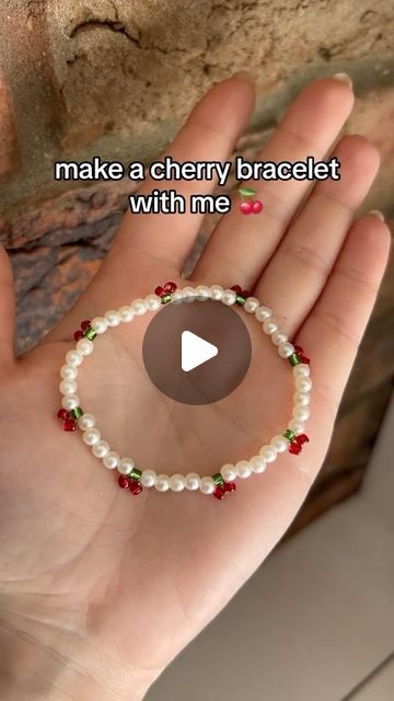 auras moonstone 🌙✨ on Instagram: "🍒cherries🍒  The sun really decided to sabotage my whole video there!🤣❤️   #friendshipbracelets #cherries #cherrybracelet #swiftie #erastour #bracelettutorial #beadedcherry #tutorial #cherry #bracelet" How To Make A Cherry Ring, Cherry Diy Crafts, Cherry Bracelet Beads, How To Make Cherry Bracelet, Cherry Lips Bracelet, How To Make A Cherry With Beads, Cherry Bracelet Tutorial, Cherry Beads Tutorial, How To Make Fancy Eras Tour Bracelets