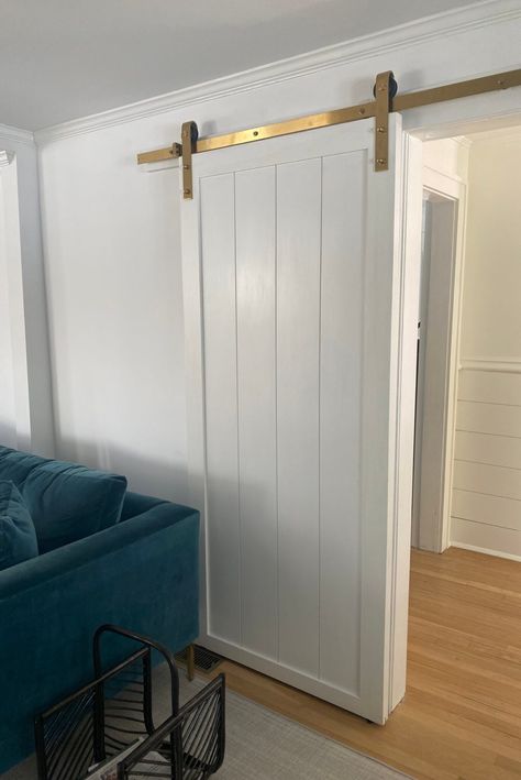 Barn Door Wainscoting, Medium Wood Floors, Shiplap Barn Door, Door In Living Room, Living Room With White Walls, Shiplap Room, Shiplap Door, Barn Door White, Room With White Walls