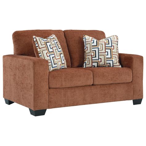 Looking to make a bold statement with color? Liven up your living room with this Aviemore Stationary Sofa and Loveseat Set. Its trend-right burnt orange upholstery adds a playful pop of color to your decor. Bold and eclectic accent pillows complete the look. Pairing posh style with everyday comfort, this piece is a welcome addition to contemporary spaces. Additional Dimensions: Arm height: 25" Sofa's distance between arms: 70" Loveseat's distance between arms: 46" Seat depth: 21" Seat height: 20" Top of cushion to top of back: 19" Leg height: 3" Minimum width of doorway for delivery: 32" Toss pillow: 22" Sofa And Loveseat, Sofa And Loveseat Set, Toss Pillow, Posh Style, Toss Pillows, Nebraska Furniture Mart, Burnt Orange, Love Seat, Accent Pillows