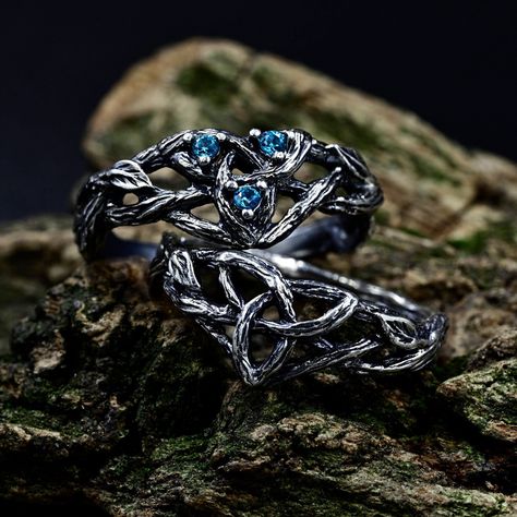 Crafted from sterling silver, our matching Viking wedding bands boast intricate designs inspired by celtic forests, perfect for couples seeking a unique symbol of their love. The wiccan love knot engagement ring adds a touch of mystique, while the aquamarine fantasy branch enhances its ethereal charm. This non-traditional set, featuring delicate branch and leaf motifs intertwined with celtic trinity knots. Characteristics: Metal - Recycled solid sterling silver  Stone - Cubic Zirconia Finish - Oxidized. View all silver celtic engagement rings: https://www.etsy.com/shop/TinyShinyJewel?ref=seller-platform-mcnav&section_id=44336419 Care instructions: To care for the ring, avoid contact with water and chemicals such as perfumes and lotions. When the ring is not in use, store it in a dry, cool Viking Wedding Ring Sets, Fantasy Wedding Rings Couple, Viking Engagement Ring, Celtic Forest, Fantasy Wedding Rings, Celtic Wedding Ring Sets, Knot Engagement Ring, Forest Ring, Viking Wedding Ring