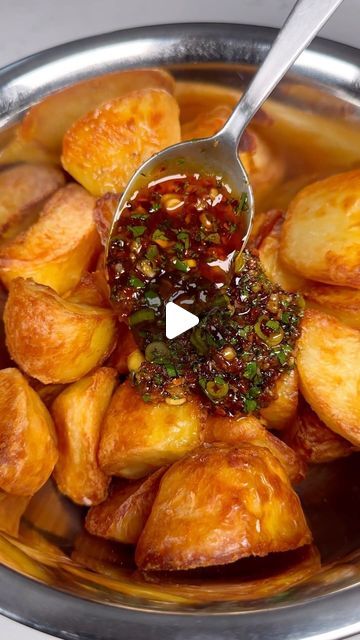 Sam Stern on Instagram: "Chilli, garlic & honey roast potatoes! 
These are a delicious variation on the classic roast potatoes. The sweet & spicy garlic sauce goes so well with the buttery crunch of the roast potatoes. Who wants one? 
Recipe:
1.5kg maris pipers, peeled and cut into even chunks 
Salt
1/2 tsp bicarbonate of soda 
Olive oil

1 tbsp crushed garlic
3 tbsp chilli crisp- I used Lao Gan Ma brand
1 1/2 tbsp honey 
1 1/2 tbsp light soy sauce 
1 tbsp rice vinegar 
2-3 spring onions, finely sliced 
A handful of coriander, finely sliced 

1. Preheat your oven to 190c fan.
2. Add the potatoes to a large pan of cold water. Add salt, bicarb and bring to the boil. Boil until a knife slips through easily, around 10-15 minutes. Drain and allow to steam dry.
3. Pour a generous amount of oil i Boiled Potato Recipes, Boiled Potatoes Recipe, Chilli Crisp, Spicy Garlic Sauce, Spring Potato, Classic Roast, Steamed Potatoes, Garlic Honey, How To Make Potatoes