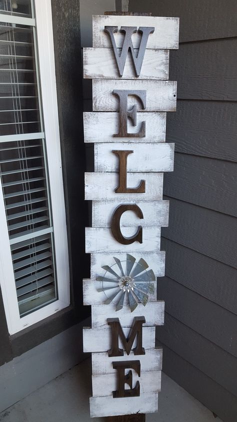 DIY project made from pallet wood. The "O" is interchangeable. Replace with a heart for Valentine's Day, or a mini wreath for Christmas, etc. The main board is a piece of wood I had laying around that measures roughly 1/2" thick, 5" wide and 60" tall & the individual pieces are 3.5" wide pallet boards cut down to 10" long and wood glued to the main board after being stained. I know the C is upside down (my mistake) but nobody notices and I'm ok with that. Door Signs Diy, Wooden Welcome Signs, Porch Welcome Sign, Diy Wood Signs, Scrap Wood Projects, Christmas Outdoor, Pallet Crafts, Front Porch Decorating, Wooden Projects