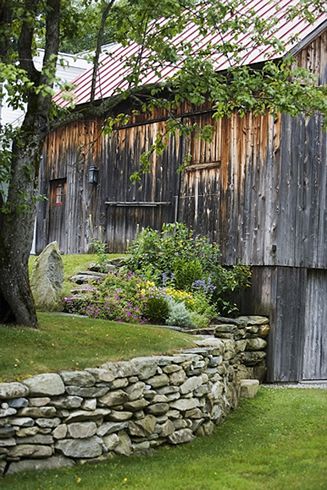 Old Country Barn + Great stacked stone retaining wall..except for the snakes. Stone Wall For Garden, Barnstone Retaining Wall, Stone Garden Fence, Backyard Patio Retaining Wall, Stone Wall In Front Of House, Old Stone Wall Garden, Rock Walls Landscaping, Fieldstone Retaining Wall, Stone Terrace Garden