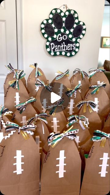 Celebrate with Melissa on Instagram: "I made this cute football shaped bag to give to the girls on our cheer squad! They turned out so cute!! Go Panthers!! 📣🏈💚 #celebratewithmelissa #cheersnacks #treatbag  #footballseason" Gameday Treats For Football Players, Football Gift Wrapping Ideas, Team Gift Bag Ideas, Gifts For Football Team, Football Party Gift Bag Ideas, Cheer Bouquet Ideas, Homecoming Goodie Bag Ideas, Spirit Bags Ideas Sports, Cheer Snack Bag Ideas