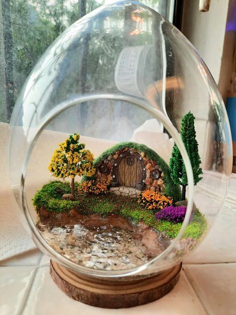 Fairy Garden World | My Hobbit House Fairy Garden Terrarium with waterscape | Facebook Las Vegas, Garden Hobbit House, Hobbit Terrarium, Hobbit Hole Decor, House Terrarium, Fairy Garden Terrarium, Garden World, Miniature Landscape, Hobbit House