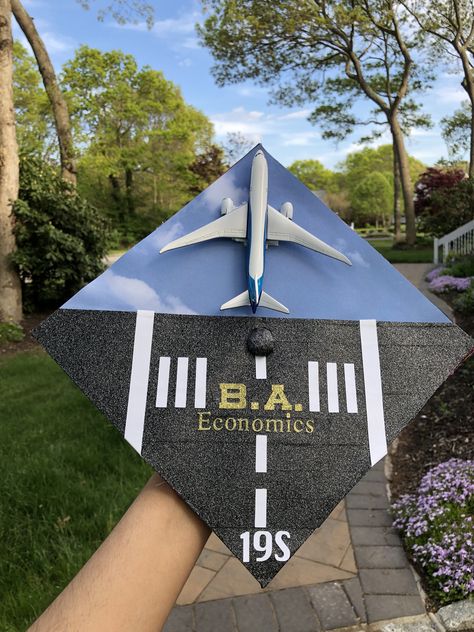 An airplane runway ready to take off into a new adventure! The plane was velcroed on so it can be positioned as a landing and take off. #flightschool #airplane #pilot #graduation #gradcap #runway #airforce #airforcegraduation #planes #flying #pilotschool #graduationcap Plane Graduation Cap, Pilot Graduation Party, Airplane Runway, Aerospace Graduation Cap, Airplane Graduation Cap, Aviation Graduation, Aerospace Engineering Graduation Cap, Air Force Graduation Cap, Aviation Graduation Party