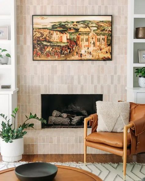 a fireplace clad with neutral skinny tiles is a stylish solution for a modern or mid century modern space