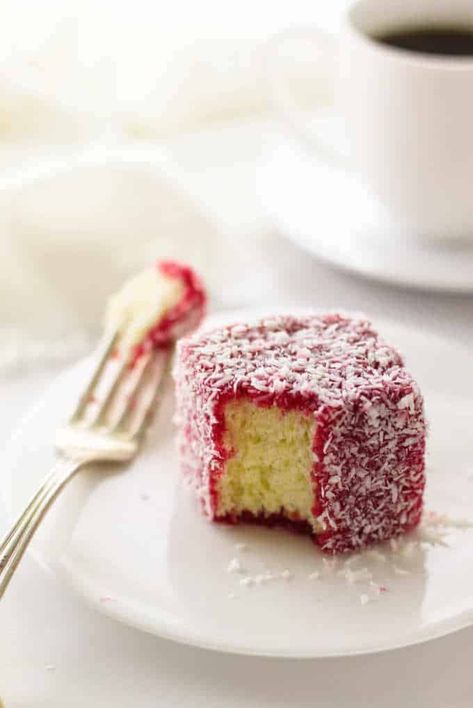 These miniature cakes are drenched in a luscious raspberry glaze and coated in coconut. Raspberry Lamington's are my new addiction. #cake #dessert #valentivedessert Raspberry Lamingtons, Lamington Recipe, Lamingtons Recipe, Raspberry Glaze, Lolly Cake, Molten Chocolate Lava Cake, Raspberry Desserts, Raspberry Coconut, Chocolate Lava Cake