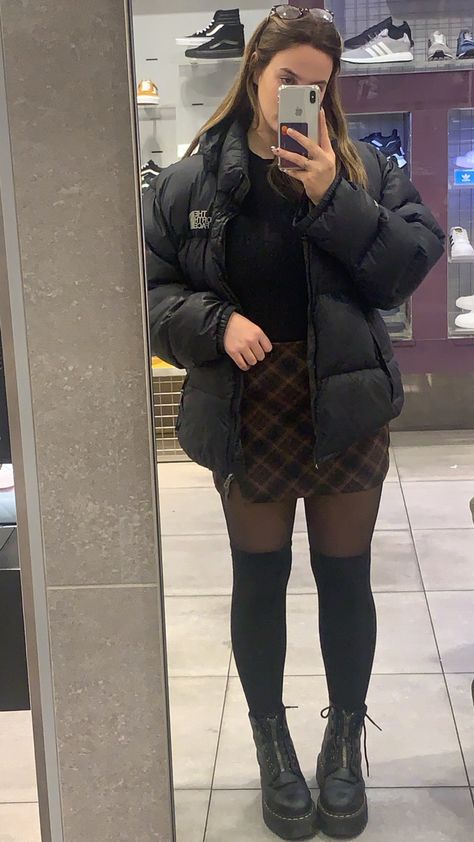 Dr martens plaid skirt knee high socks north face puffer Plaid Skirt Knee High Socks, Over Knee Socks Outfit Winter, Fits With Dr Martens, Cute Knee High Socks Outfits, Puffer And Skirt Outfit, Puffer Jacket With Skirt Outfit, Dr Martens With Socks, Skirt And High Socks, Outfits With Knee Socks