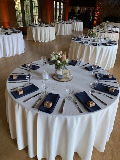 Ivory table linens with navy napkins give a subtle elegance and crisp look Navy Blue Table Centerpieces, Navy Napkins, Napkins Wedding Table, Navy Tablecloth, Navy Blue Napkins, Grey Wedding Decor, Blue Table Settings, Ivory Table, Napkin Wedding