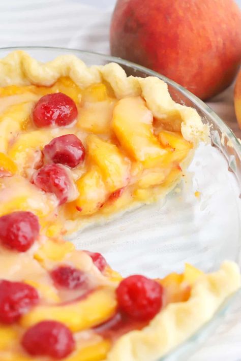 This Fresh Peach and Raspberry Pie combines the sweetness of summer peaches with the tartness of ripe raspberries all wrapped up in a buttery flaky pie crust. Serve with a dollop of whipped cream or a big scoop of vanilla ice cream for a perfect seasonal dessert. #thecarefreekitchen #pie #peaches #raspberries #freshpeachpie #dessert #summer #piecrust #whippedcream Peach Raspberry Pie, Fresh Raspberry Pie, Peach Tart Recipes, Raspberry Recipes Dessert, Berry Pie Filling, Raspberry Cream Pies, Buttery Flaky Pie Crust, Raspberry Pie Filling, Fresh Peach Pie