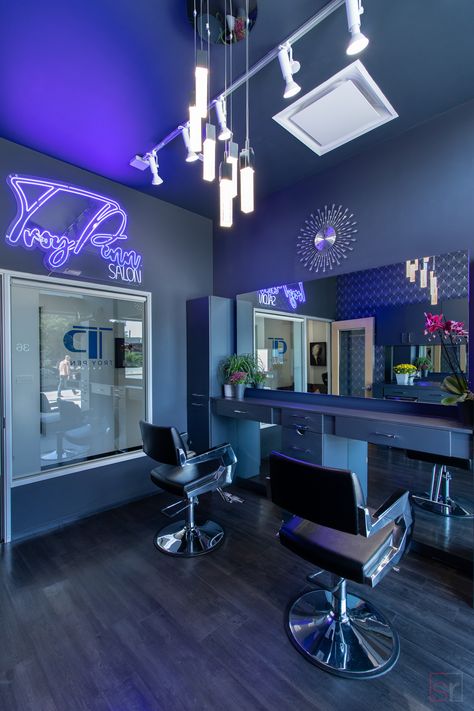 Modern private Salon Studios available for beauty professionals. This hair salon studio in Beverly Hills, California has a blue theme with a wallpaper accent wall and neon sign to create a cool, club feel. Zepeto Background Hair Salon, Navy Blue Hair Salon Decor, Lash Shop Interior, Salon Interior Design Purple, Hair Salon Room Decor, Blue Salon Ideas, Blue Lash Room Decor, Black Salon Suite Decor, Hair Salon Decor Ideas Modern