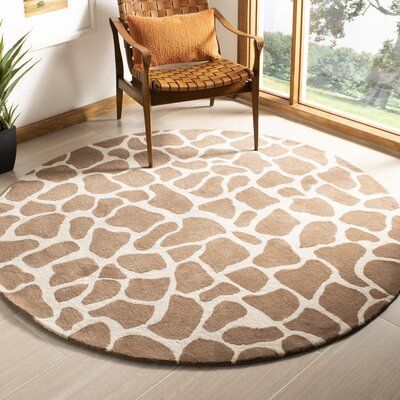 This area rug features a stylish animal print design, giving your hardwood or tile floors a subtle pop of pattern. It's tufted in India from wool, and it comes in a wide variety of sizes to choose from that best fit your space. The brown and off-white pattern is juxtaposed on top of a solid background for a subtle color contrast. Plus, this area rug comes with a high 0.63" pile height that's ideal for low-traffic rooms like the nursery or bedroom, and also ideal under your feet. To keep it from Giraffe Bedroom, Giraffe Room, Giraffe Decor, Safari Theme Nursery, Giraffe Nursery, Nursery Room Design, Jungle Nursery, Nursery Room Inspiration, Nursery Baby Room