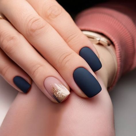 This manicure combines sophisticated matte navy nails with a single accent nail in a soft nude base topped with a gradient gold glitter. The matte texture contrasts beautifully with the glossy, shimmering accent, creating a modern and elegant look perfect for any occasion. Blue Nails Navy, Matte Navy Nails, Short Winter Nail Ideas, Dip Nail Art, Gold Accent Nails, Dip Designs, Nail Shapes Squoval, Gold Accent Nail, Winter Nail Ideas