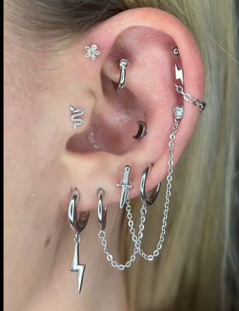 Ear Piercing Set Up Goth, Celestial Piercings, Silver Ear Curation, Grunge Ear Piercings, Ear Curation Silver, Helix Piercing Aesthetic, Helix Ear Piercings, Ear Piercings Silver, Ear Piercings Ideas