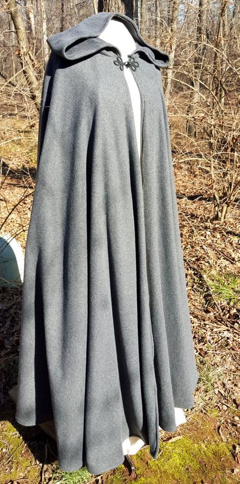 This long dark grey cloak is a full circle of soft warm fleece, giving it wonderful movement and flow. This full length cloak is 58 long. It has a full hood and closes with a matching cloth frog. This cloak is a great costume piece for your local renaissance faire or festival and is comfortable for Cloak Outfit, Cloak Pattern, Chica Dark, Long Cloak, Winter Cloak, Medieval Cloak, Hallowen Costume, Hooded Cloak, Period Outfit