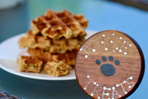 some waffles are on a plate with a dog paw painted on the side