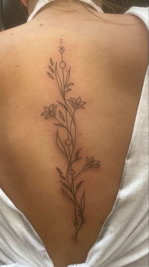 Tattoo Ideas On Your Side, Mother Daughter Tattoos Ribcage, Matching Spine Tattoos For Best Friends, Tangled Spine Tattoo, July Birth Flower Spine Tattoo, Leo Spine Tattoo, Spine Tattoo Meaning, Dainty Floral Spine Tattoo, Flower Placement Tattoo