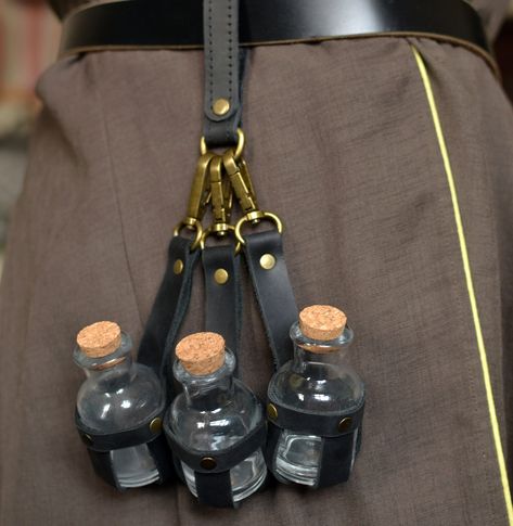 The set includes  three pieces of black leather potion holders.  Made of genuine leather and original fittings, which gives the product an authentic look. Each holder contains a glass bottles with a cork stopper (30 ml = 1 oz).  The spring hook makes it easy to attach and detach holders to belts and to any loops on clothes  Additionally, if necessary, you can order a loop for fastening The holder can be used for its intended purpose,  in role-playing games in the style of steampunk or Victorian Steampunk Belt, Larp Props, Crochet Belt, Fairy Accessories, Steampunk Wedding, Steampunk Accessories, Belt Accessories, Leather Pieces, Fantasy Clothing