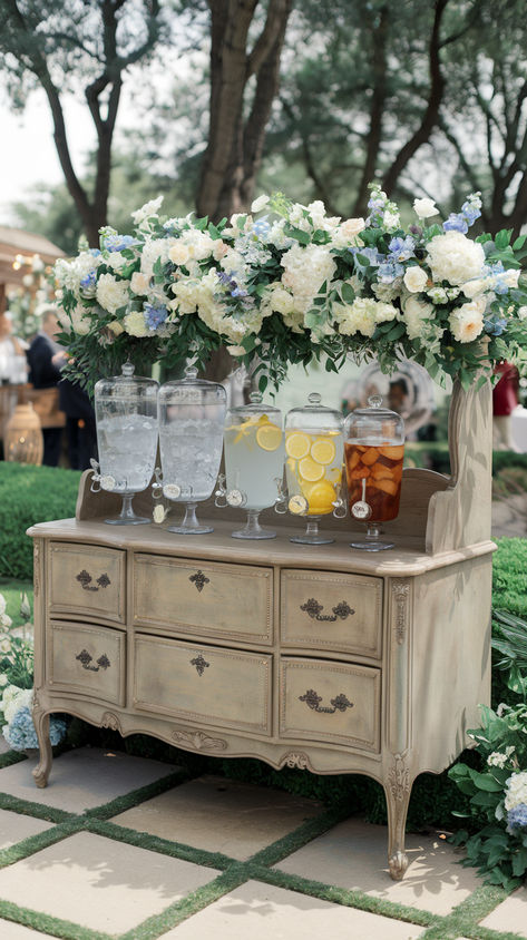 Hydrating drink station containers at an outdoor spring wedding How To Serve Drinks At A Wedding, Choose A Glass Its Yours To Keep Wedding, Diy Drink Station Wedding, Self Serve Open Bar Wedding, Ceremony Drinks Station, Wedding Cocktail Hour Indoor, Backyard Spring Wedding Ideas, Fun Wedding Reception Ideas Food Stations, Outdoor Bar Ideas For Party