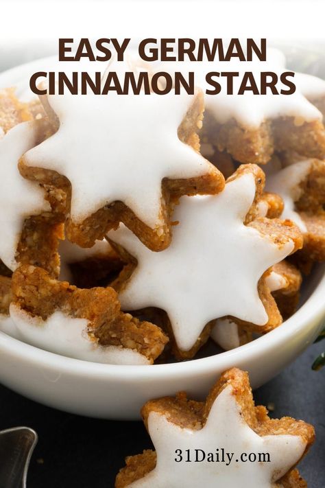 German Cinnamon Star Cookies, also known as Zimtsterne, are delicious and traditional holiday Christmas cookies. Tiny, shaped stars with meringue icing are made with 3 main ingredients: egg whites, cinnamon, and almond flour. This delicious and endearing Christmas tradition are perfect Christmas cookies to make this holiday season! Shaped Christmas Cookies, Star Christmas Cookies, Cinnamon Star Cookies, Holiday Christmas Cookies, Cinnamon Christmas Cookies, Christmas Confections, Meringue Icing, German Christmas Cookies, Christmas Cookie Recipes Holiday