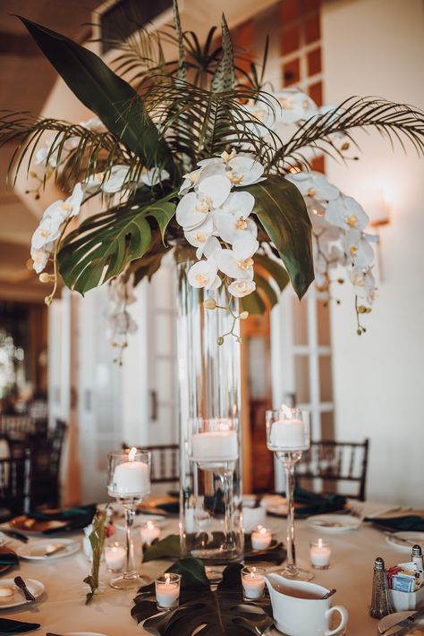 Elegant Tall Centerpieces, Tropical Wedding Seating Chart Ideas, Modern Tropical Wedding Ceremony Decor, Black Tie Tropical Wedding, Classy Tropical Party, Palm Leaf Centerpiece Wedding, Tropical Bud Vases Wedding, Tropical Art Deco Wedding, Palm Floral Arrangements