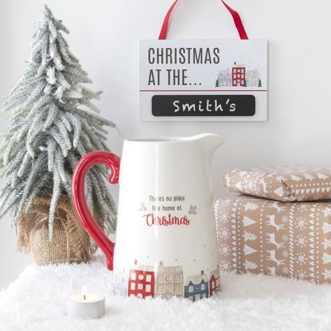 *Trade/Wholesale only. This decorative flower jug is ideal for keeping your favourite festive flowers in the run-up to Christmas. The flower jug features the text 'There's no place like home at Christmas' above a festive stree of colourful houses with snow topped roofs with stars decorating the sky. The image also features 'Christmas at the...Chalkboard sign' allowing you to add your family surname and hang on a door handle. Christmas Text, Jug Vase, Ceramic Jug, No Place Like Home, Winter Flowers, Ceramic Flower, Christmas Scene, Chalkboard Signs, Spiritual Gifts