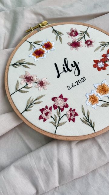 Nini • Embroidery Artist 🪡 on Instagram: "One of the best ways to embroider near the edge is to use a bigger hoop than the pattern 🪡 Pro tip: make sure the pattern is bigger than the original hoop size! Follow for more embroidery tips & tricks!" Embroidery Lily Flower, Lily Embroidery Pattern, Lilly Embroidery, Lilies Embroidery, Embroidery Lily, Embroidered Lily, Beanie Embroidery, Embroidery Names, Lily Embroidery