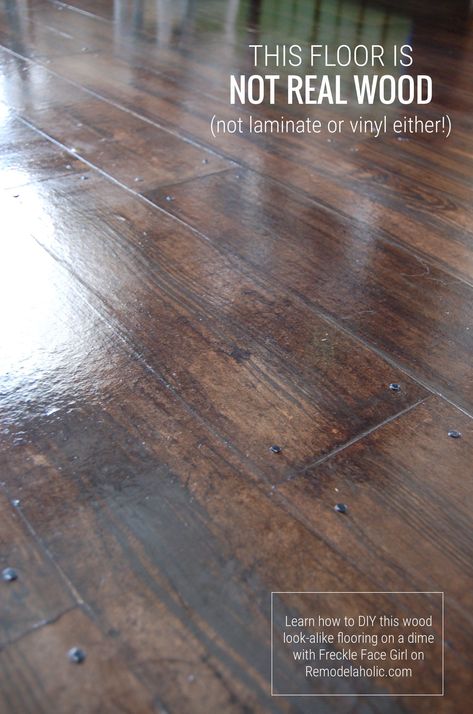 Want the look of a wood floor at a lower cost? This DIY faux wood flooring uses brown paper and costs less than hardwood, laminate, or vinyl tile. #diyflooring #brownpaperflooring #budgetremodel Faux Painted Wood Floors, Wood Subfloor Makeover, Faux Wood Concrete Floor Diy, Faux Tile Concrete Floor, Wood Block Flooring Diy, Faux Wood Flooring Tile, Wood Look Concrete Floor, Repurpose Hardwood Flooring, Faux Stone Floor