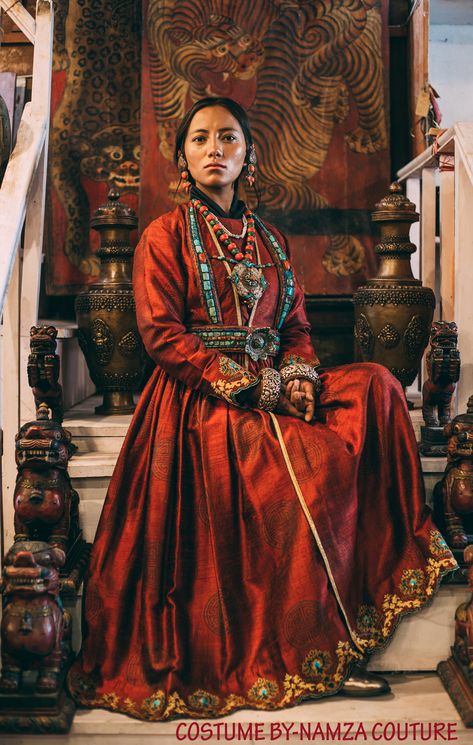 Wearing Ladakhi Culture means, you wearing a Ladakhi dress and Ladakhi jewellery. A "Sulma" in this picture is the red gown. The big coral earrings "Akor". The turquoise and coral necklace with a big amulet "Gau", which is considered the main piece of jewellery in Ladakhi wedding. Then below that is an ornament worn by the women of Sham valley, its called "Rhuptsey". The top part is tied to the neck and the bottom part around the waist so that the lotus-shaped jewellery is right in the centre. Traditional Ladakhi Dress, Cultural Outfits Traditional Dresses, Ladakhi Dress, Cultural Dress, Cultural Clothing, Culture Clothing, Asian History, Period Outfit, Coral Earrings