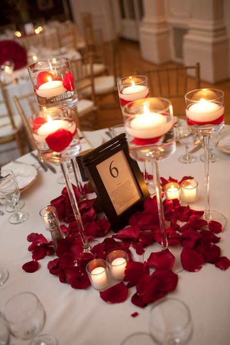 something so simple yet so elegant and romantic.Candle centerpieces with rose petal accents Rose Petal Candle, Red And White Weddings, Candle Table Decorations, Red Rose Petals, Wedding Centerpieces Diy, Rose Candle, Diy Centerpieces, Tree Wedding, Candle Centerpieces