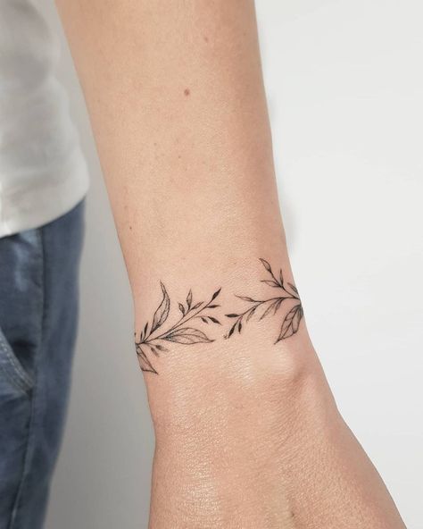 Collar Bone Writing Tattoo, Fineline Wrist Tattoo, Vine Around Wrist Tattoo, Womens Wrist Tattoos, Laurel Leaf Tattoo, Wrist Cuff Tattoos For Women, Around Wrist Tattoo, Flower Bracelet Tattoo, Spiral Tattoos