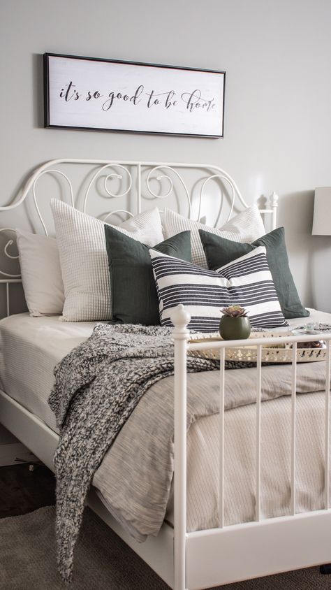 White & Grey Bedroom. Bedroom designed and styled with Ikea bedframe, toss cushions, & linens. Cozy and modern, great for a guest bedroom. Wall colour is Benjamin Moore Gray Owl. Airdrie, AB, Rocky View County, AB. eDesign. Leirvik Bedframe. #bedroomstyling #bedroomdesign #whitebedframe #ikeacanada #sparebedroomdecor #greendecor #grayowl #whtietosscushions #whitepillows #blackandwhite #blackandgrey #whiteandgrey #whiteandgreybedroom #whiteandgreenbedroom #greyandgreenbedroom #whitegreygreen Ikea Bedframe, Ikea Metal Bed, White Grey Bedroom, Ikea Style Bedroom, Grey Green Bedrooms, White Iron Beds, Ikea Bedding, Ikea Bed Frames, White Metal Bed Frame