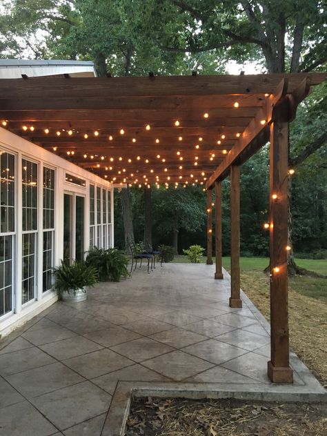 Back Porch With Lights, Small Deck String Lights, String Lights Rectangle Patio, Concrete And Wood Patio Ideas, Western Back Porch Ideas, Pergola Lights Ideas, Lights On Pergola Outdoor, Concrete Deck Ideas, Table On Porch