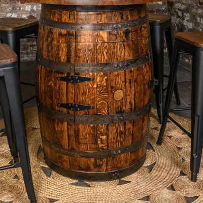 Make your gathering space for family and friends special. Want extra storage for your bottles and glasses? No problem, our Deluxe Pub Table features a built-in cabinet with a 360-degree lazy susan and motion-activated, cordless, rechargeable shelf light. This handcrafted beauty is made from a fully refurbished (cleaned, sanded, stained, and clear-coated to have a robust and beautiful finish), authentic, whiskey barrel. Included is a matching 48" solid oak tabletop. | Mystic Barrels Bar w / Wine Wine Storage Wood, Bar With Wine Storage, Whiskey Barrel Table, Shelf Light, Barrel Bar, Whiskey Barrels, Pub Tables, Barrel Table, Built In Cabinet