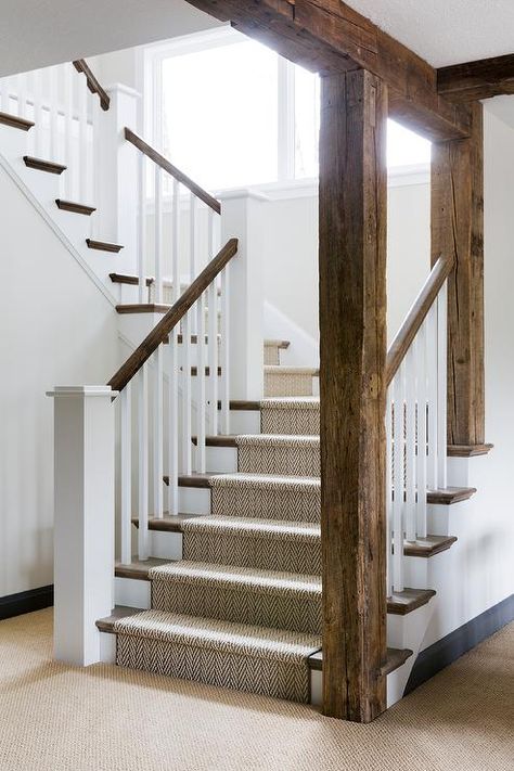 Rustic wood beams accent a white staircase contrasted with a stained railing and stained treads covered by a jute herringbone runner. Exposed Wood Beams, Small Basement Remodeling, Bria Hammel Interiors, Rustic Staircase, Bria Hammel, Stairs Railing, Stairs Storage, Rustic Basement, Railing Ideas