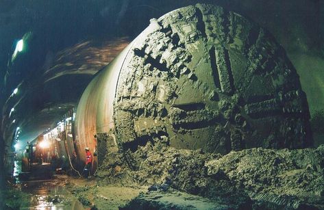 A tunnel boring machine (TBM), also known as a "mole", is a machine used to excavate tunnels with a circular cross section through a variety of soil and rock strata. They may also be used for microtunneling. They can bore through anything from hard rock to sand. Tunnel diameters can range from one metre (3.3 ft) (done with micro-TBMs) to 17.6 metres (58 ft) to date. Atheism Humor, Tunnel Boring Machine, Ufo Art, Construction Machines, Cross Section, Cloud Gate, Mole, Hard Rock, Engineering